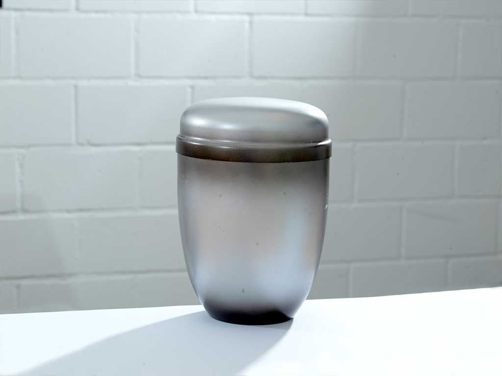 A simple urn containing cremation ashes